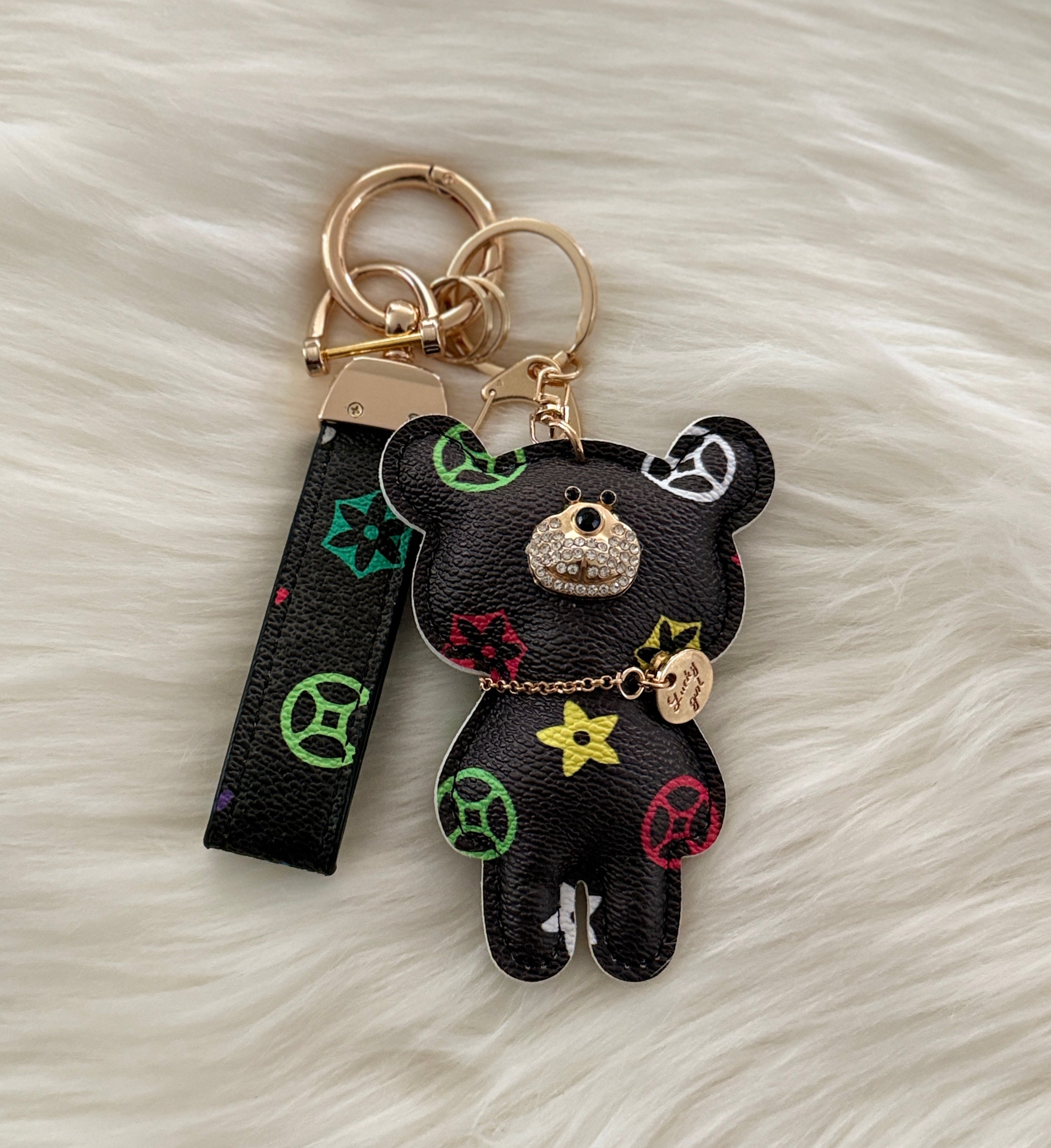 Black teddy charm keychain with matching strap and clasp.
