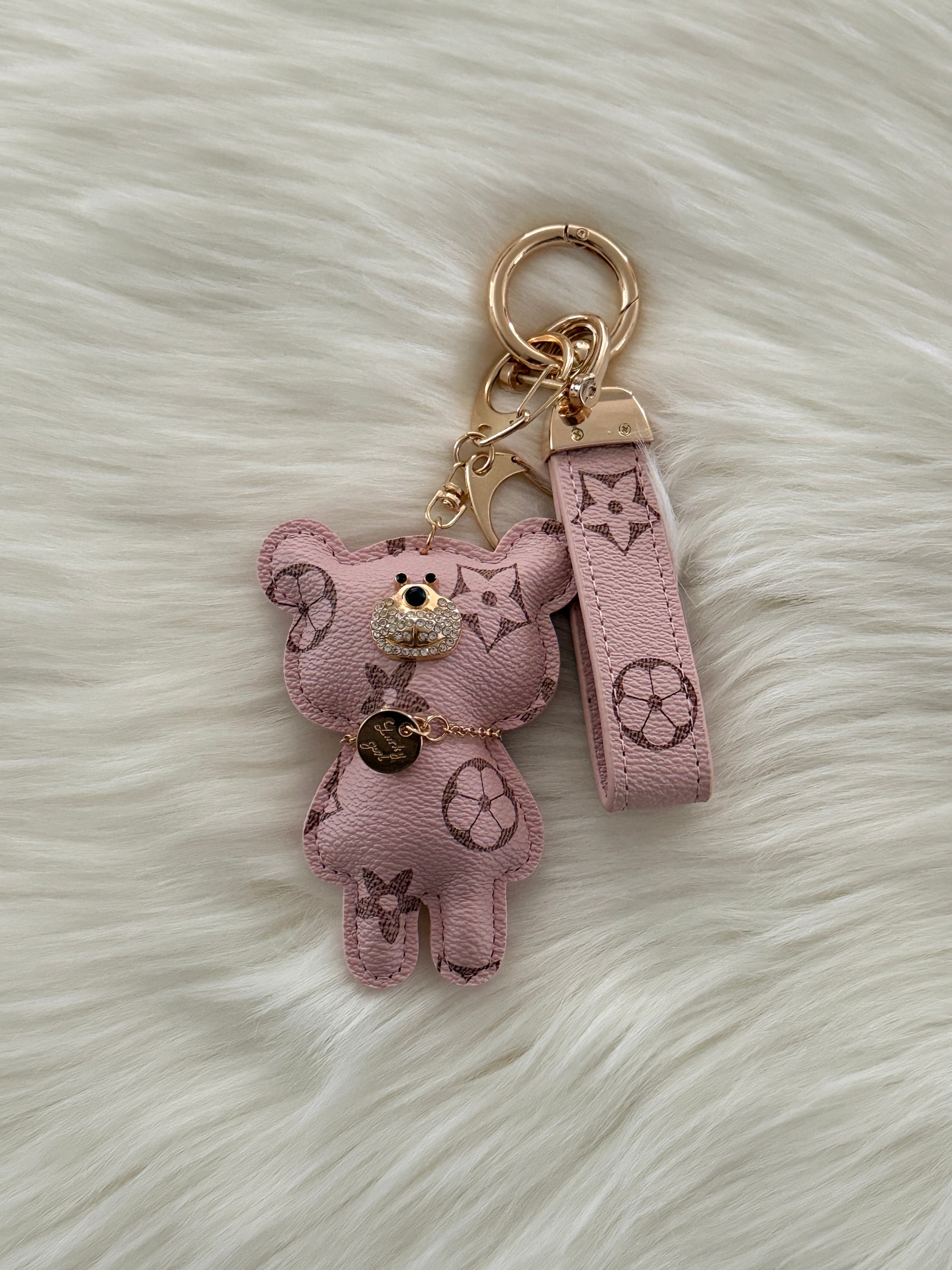 Pink teddy charm keychain with matching strap and clasp.