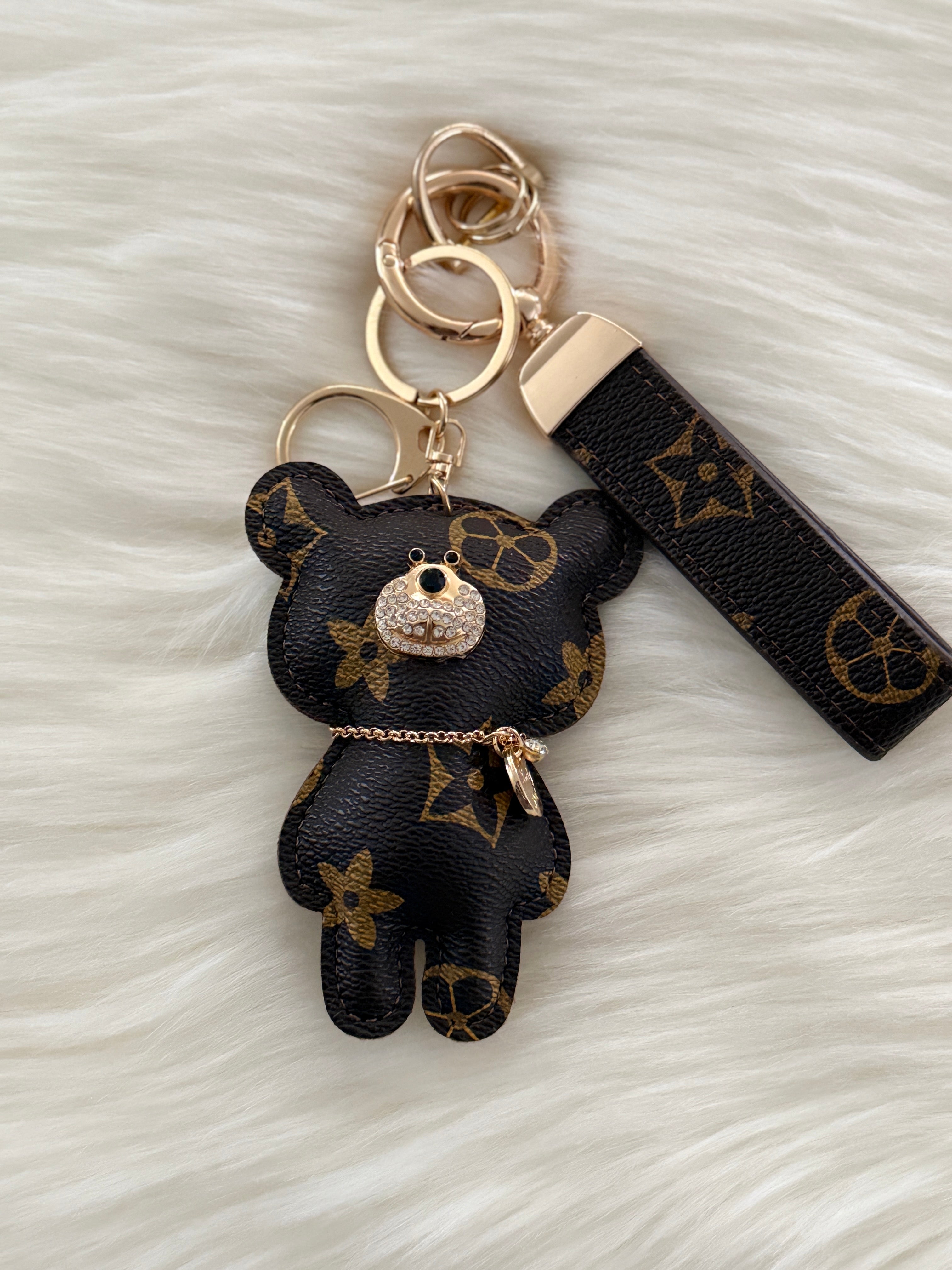 Brown teddy charm keychain with matching strap and clasp.